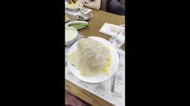 Tasting the national dish of Jordan called Mansaf made of chicken, a sauce of fermented yoghurt and rice in a local restaurant of the downtown of Amman.