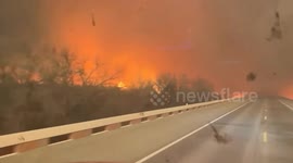 Firefighters drive through hellish scene as wildfires rip through Texas