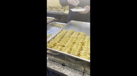 Purchasing traditional Arabic sweets from a local patisserie in the downtown of Amman, the capital city of Jordan.