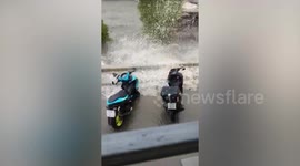 Tidal waves flood carpark beside canal