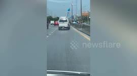 Unsteady car with crooked wheels drives along road in Thailand