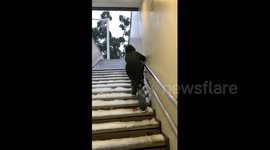 Woman Struggles Climbing a Snow-Covered Staircase in Hunan, China