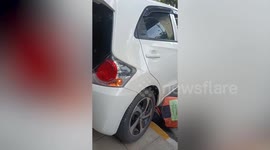 Motorcycle taxi riders help save kitten stuck under car