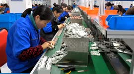 Workers are working on a circuit breaker production line in Fuyang, China