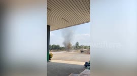 Dust devil tornado creates dark spinning column of dirt
