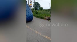 Overloaded pickup truck topples backwards when it tries to drive uphill