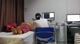 A doctor gives a neuromyogram examination to a patient at a hospital in Yichang, China