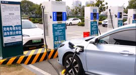 Vehicles are charged at a charging pile in a parking lot in Yichang, China