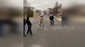 Police officers play with local kids through a basketball game