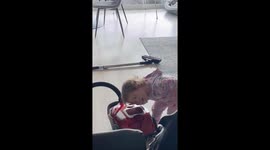 Sweet toddler girl tries drying her hair with the Hoover Vacuum Cleaner