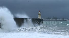 Massive storm waves hit lighthouse pier at Newlyn harbour in Cornwall