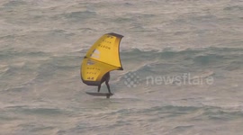 UK Weather, Hydro Blade Kiting after downpours and flooding South West England. Fistral Bay, Cornwall, UK