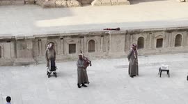 Traditional musicians from Jordan playing bagpipes and oriental percussion in the Jerash Roman Theater in the archeological site. Jerash is Climbing on the Roman Theater in Jerash archeological site, Jordan. Jerash is an ancient city located in Jordan tha