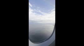 Landing on Kastrup Copenhagen Airport on an airplane. The airplane flies over the water of the Baltic sea before landing.