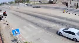 Lorry barrels through intersection and drags car across highway