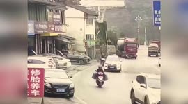 Motorcyclist makes miraculous escape as lorry strikes and drags bike along road