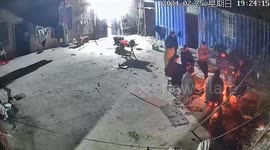 Neighbours gathered around small campfire jump from seats when it suddenly explodes