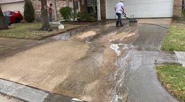 Man pressure washing driveway