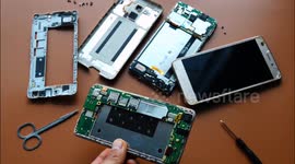 A citizen shows a dismantled used mobile phone in Yichang, China