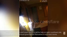 Police officers remove raccoon that broke into home in middle of the night