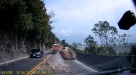Chilling footage shows boulder nearly crashing into speeding car