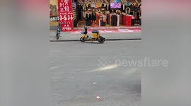 Riderless electric bike circles on its own outside store
