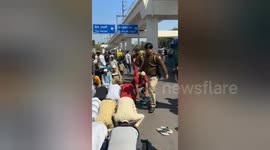Police constable hitting people offering Namaz on a road in Indian capital Delhi's