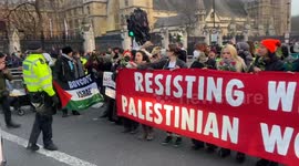 Pro-Palestine protesters block the traffic in Parliament Square in solidarity with women and children in Palestine