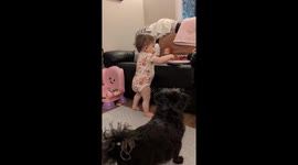 Baby feeds dog chips to try and get dog to be her friend