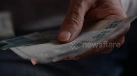 Close-up of a person's hands counting money from money laundering.