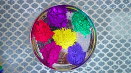 Baby girl playing color with her family members on Holi Festival in India