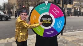 Rishi Sunak look-a-like spins Rwanda bill ‘wheel of misfortune’ outside Parliament in London ahead of Rwanda Bill vote