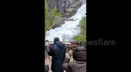 Terrified tourists flee as massive snowball rolls down, breaking barriers at Chinese scenic spot