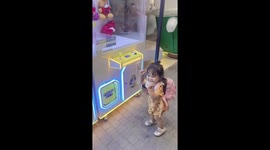 Toddler delighted to win on her first claw grabber game