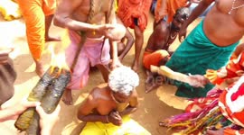 Coconuts smashed on devotees' heads in bizarre Hindu ritual
