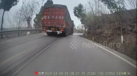 Truck overturns on mountain road in China after avoiding collision with a van