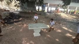 Skillful schoolboys use garden table for 'Teqball'