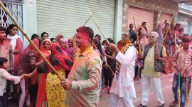 Indian people take part in traditional stick dance during Holi celebrations in India