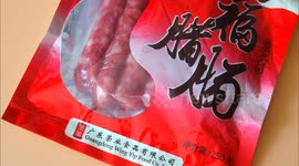A citizen shows Hongfu sausage in Yichang, China