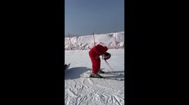 Seamless Coordination in China: Duo Showcases Synchronized Sitting Skiing