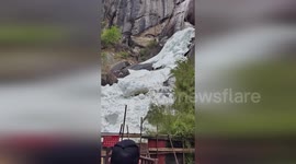 Scared tourists run for their lives to escape massive snowball coming their way