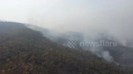 Fire started from illegal forest burning sweeps through mountain in Thailand