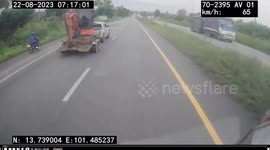 Pickup truck towing excavator spins out of control