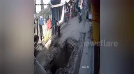 Dramatic footage shows a biker fell into an open pit in the middle of the road in Northern India, locals runs to rescue