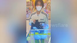 Boy brings bag full of money to shop to buy phone
