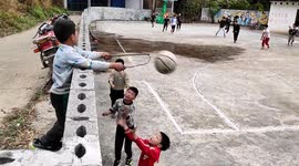 Resourceful boy in Chinese village improvises basketball hoop to join game
