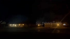 Lighting illuminates night sky revealing tornado in central Indiana