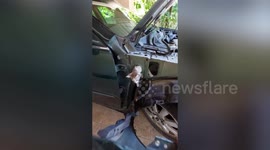 Driver removes side panel of his car to rescue stray cat stuck inside