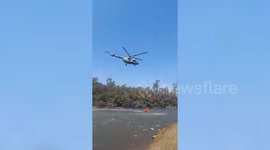 Officials use helicopters to control wide spread forest fire in southern india