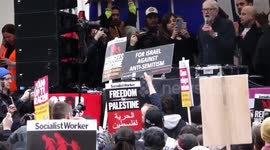 Pro-Israel protester escorted away by police for holding a placard in front of Jeremy Corbyn MP as he addresses the Rave against Racism in Whitehall, London.
